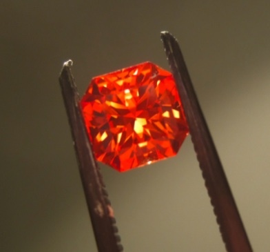 Small faceted orange-pink stone described by the photographer as padparadscha. Example only, not stock.